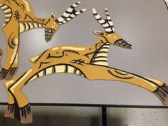 an image of two deers that are made out of wood and acrylic paint