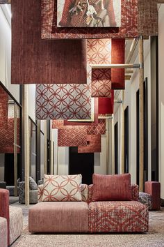 a living room filled with lots of red and white couches next to each other