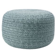 the large round poufle is made from woven fabric and has a light blue color