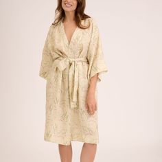 Custom print on linen. Small batch. Luxurious and delicate designs speak of the magic of summer inviting to relax. The robe kimono is cut for a relaxed fit, ensuring it looks flattering on many body shapes. It features generous kimono proportions and is fastened with a linen sash tie.   Linen is a naturally anti-static fabric that collects less dust and is therefore healthier for you. Linen is a 100% plant-based fabric. Its cultivation and production conserves water, does not pollute, does not l Beige Robe With Kimono Sleeves For Spring, Beige Kimono Sleeve Robe For Spring, Cream Kimono For Daywear In Spring, Spring Cream Kimono For Loungewear, Cream Kimono For Spring Loungewear, Beige Spring Dress With Kimono Sleeves, Elegant Linen Dress With Floral Print, Beige Linen Robe For Spring, Elegant Cream Linen Day Dress