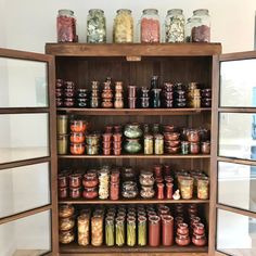 the shelves are filled with many different types of jars