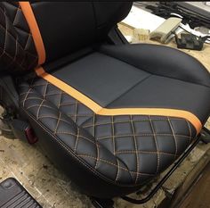 there is a black and orange seat on the motorcycle