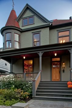 a large house with many windows and steps leading up to the front door