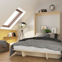 a bed sitting under a skylight in a bedroom