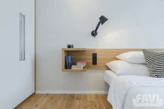 a bedroom with white walls and wood flooring