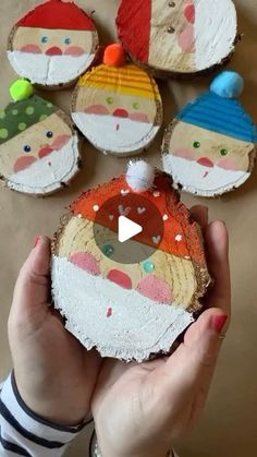 someone is holding up some wood slices to show how they look like santa clauss