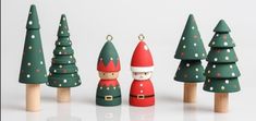 small wooden christmas trees with santa and other decorations