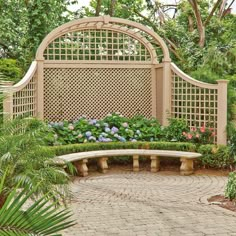 the cover of an outdoor magazine features a bench and flower garden in front of a pergolated trellis