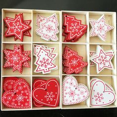 a box filled with red and white decorated cookies