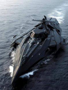 a large black boat in the middle of the ocean