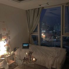 a living room filled with furniture and a laptop computer on top of a glass table