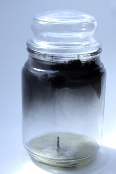 a glass jar filled with liquid sitting on top of a table