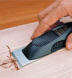 a person using a sharpener on a piece of wood