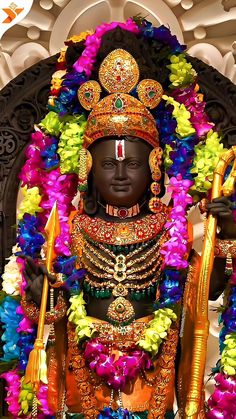 the statue is decorated with flowers and garlands