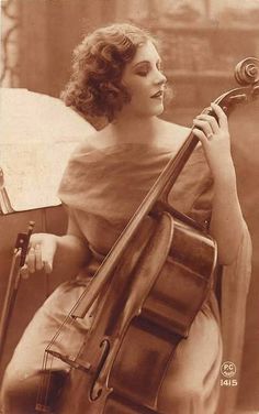 an old photo of a woman holding a violin