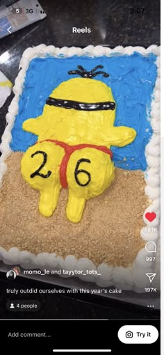 a birthday cake with the number twenty six on it and a cartoon figure in the middle