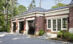 a brick building with white trim and black doors