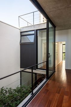 an open balcony with wooden flooring and glass doors leading to the upper level bedroom