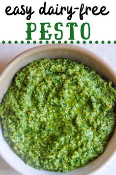 a bowl filled with pesto on top of a table