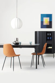 a black table with two chairs and a cabinet