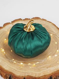 a green bag sitting on top of a tree stump with lights around it's edges