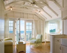 a living room filled with furniture and windows