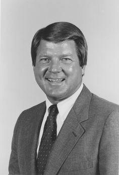 a black and white photo of a man in a suit