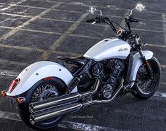 a white motorcycle parked in a parking lot