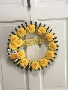 a yellow and black wreath hanging on the front door