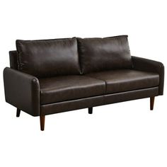 a brown leather couch sitting on top of a white floor