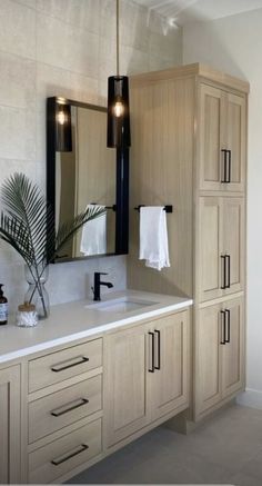 a bathroom with two sinks and cabinets in it