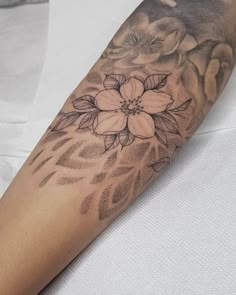 a woman's arm with flowers on it