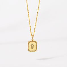 Timeless, elegant, and classy - our gold initial pendant necklace gives a personal touch to any outfit. This 18-20" personalized necklace features a gold pendant with an initial that is framed by shimmering crystals and the empowering message “I am Beautiful, Resilient, Strong, Enough, Loved ”is delicately engraved on the back. Tough days don't stand a chance against your inner fire! Wear this gold initial necklace to remind yourself that you are beautiful, loved, enough, strong, and resilient t Elegant Gold Initial Necklace With Name Detail, Gold Initial Pendant Necklace With Name, Gold Rectangular Initial Necklace For Personalized Gift, Elegant Gold Rectangular Initial Necklace, Gold Monogram Initial Pendant Necklace, Gold Rectangular Initial Necklace For Anniversary, Gold Rectangular Initial Necklace, Gold Initial Necklace With Rectangular Pendant, Gold Initial Necklace With Square Pendant For Anniversary