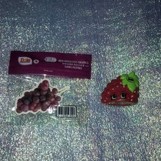 there are grapes and strawberries in the bag on the floor next to each other