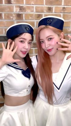 two young women dressed in sailor outfits posing for the camera