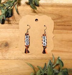 These one of a kind beaded boo and eek word earrings are so fun and festive! They are perfect for spooky season and trick or treating!! They are backed with a beautiful black glitter faux leather. Refer to photo for sizing details. **Earring hooks are made from hypoallergenic 316 surgical stainless steel, however may contain trace amounts of nickel. **I do my best to make all of my products as close to perfect as possible, however due to the handmade nature of the item there may be some slight imperfections. **SAFETY: This product contains small parts that could cause a choking hazard in small children. Please do not leave them unattended with the item. Diy Halloween Earrings, Halloween Earrings Diy, New Years Eve Earrings, Halloween Jewelry Diy, Thanksgiving Earrings, Word Earrings, Charm Bar, Fall Bead, Body Fashion