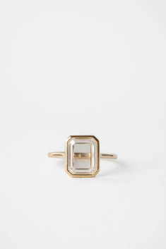 a gold and white diamond ring on a white background