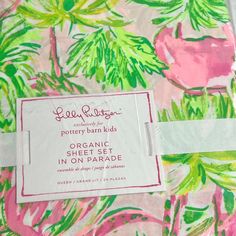 a pink and green tropical print fabric with a label on the side that says,'organic sheet set in on parade '