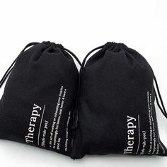 two black bags sitting on top of each other with the words new everyday printed on them