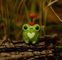 a green frog with a heart on it's head