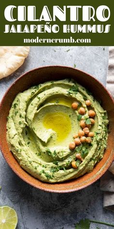 a bowl filled with guacamole and garnished with chickpeas