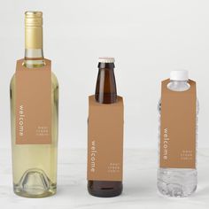 three different types of wine bottles with labels on them, one brown and one white