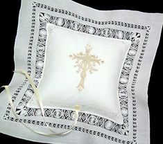 an embroidered pillow with a cross on it