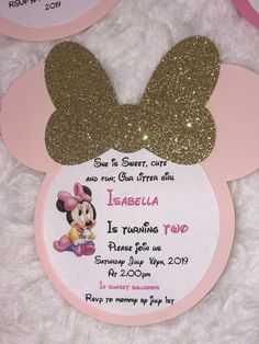 a minnie mouse birthday party with pink and gold glitters on it's ears