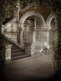 an old stone building with stairs and arches