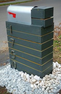 a mailbox sitting on top of a pile of rocks