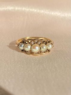 Vintage 9k yellow gold ring from Birmingham c 1989. This boat ring features a clam-shaped gold frame with five silver-tone pearls nestled within. Great vintage conditionSize: 6.5Weight: 2.2 gramsBand: 8.0 mm (front), 1.8 mm (back)Pearls: 3.0 mm - 4.0 mm x 5 Hallmarks: 375 for 9k, anchor for Birmingham, “P” for 1989, C&F for makers mark To see more photos and videos of this piece, visit my Instagram: www.instagram.com/23carat_PLEASE READ ALL POLICIES regarding shipping, returns, tax, etc. Vintage 14k Gold Pearl Wedding Ring, Vintage 14k Gold Pearl Ring, Vintage Gold Hallmarked Pearl Ring, Vintage Silver Hallmarked Pearl Ring, Victorian 14k Gold Pearl Ring, Pearl Engagement Ring, Diy Jewelry Unique, Detailed Jewelry, Future Engagement Rings