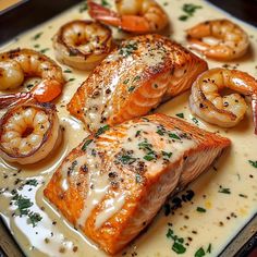 salmon and shrimp on a plate with sauce