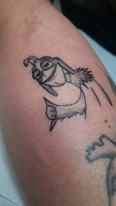 a tattoo on the arm of a man with a koala bear holding a fish