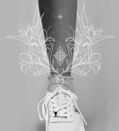 a person's foot with tattoos on it and flowers in the middle of their shoe